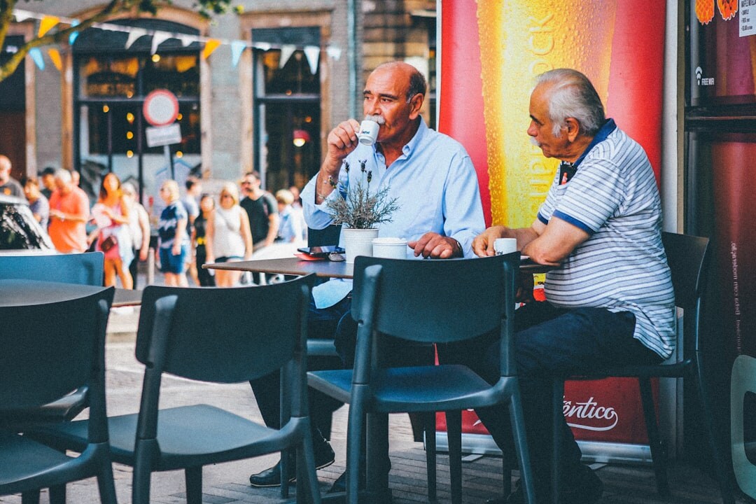 Seniors chatting and laughing over coffee at a social club